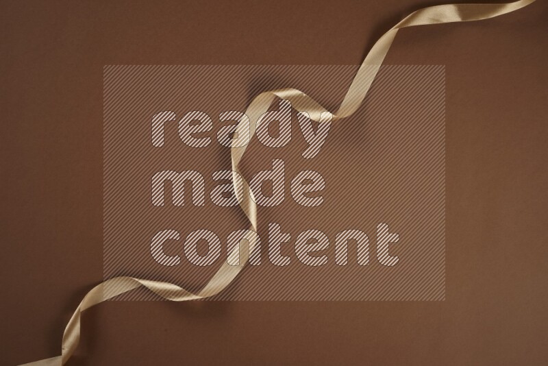 A brown collection of sewing and tailoring tools arranged on a brown background