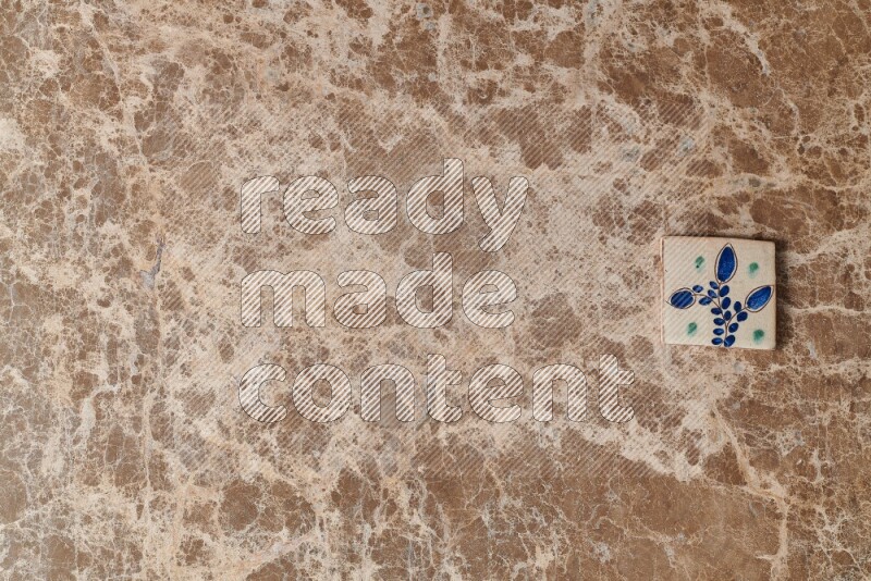 A decorative coaster on beige marble background