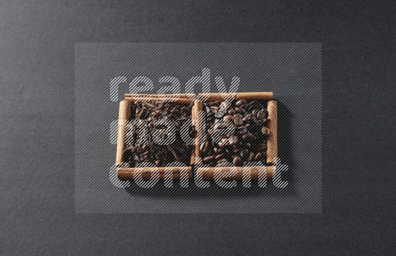 2 squares of cinnamon sticks full of coffee beans and cloves on black flooring