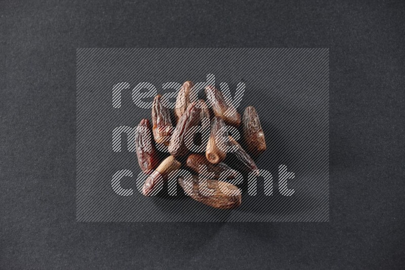 Dried dates on a black background in different angles
