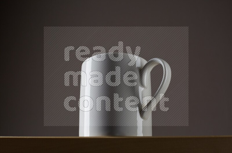 Low angle shot of a white cup on grey background