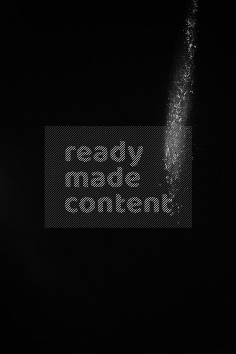 A side view of white powder explosion on black background