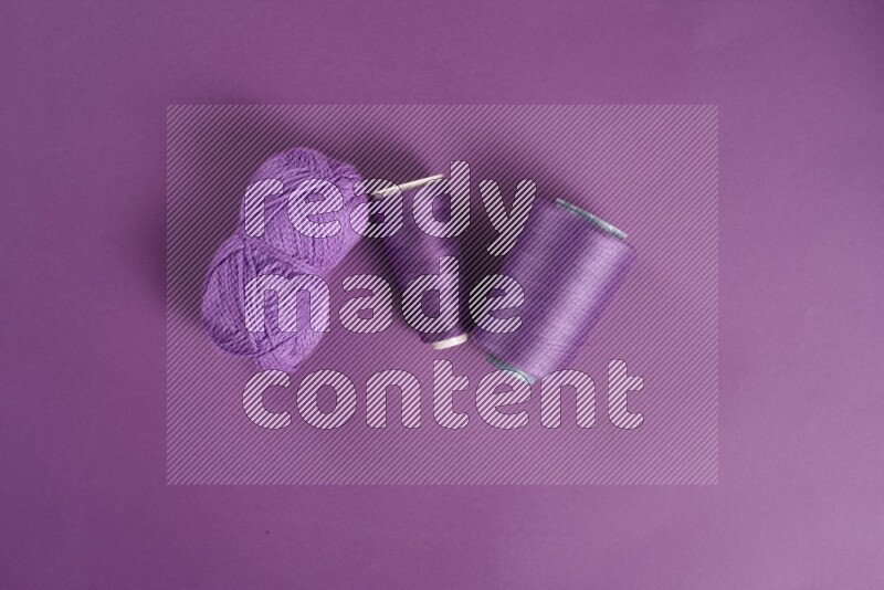 A purple collection of sewing and tailoring tools arranged on a purple background