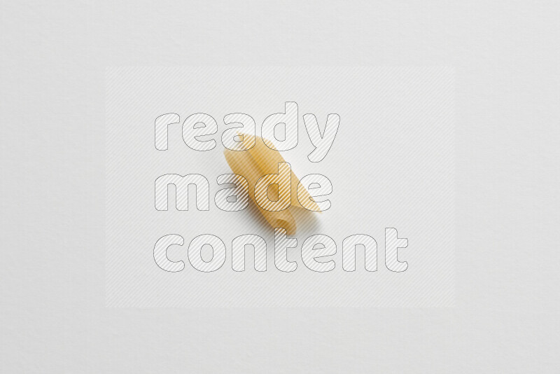 Mini penne pasta on white background