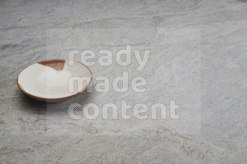 Multicolored Pottery Plate On Grey Marble Flooring