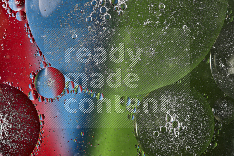 Close-ups of abstract oil bubbles on water surface in shades of red, green and blue
