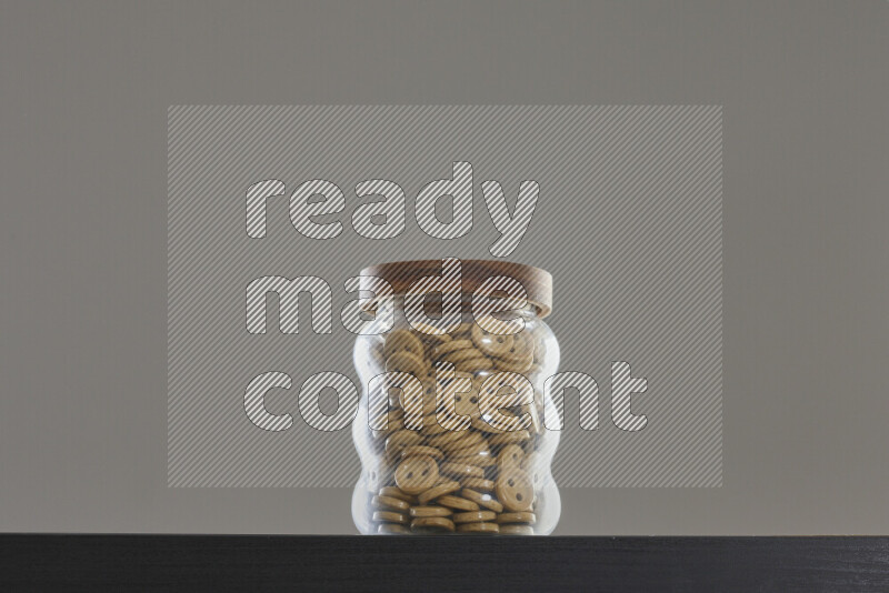 Buttons in a glass jar on black background