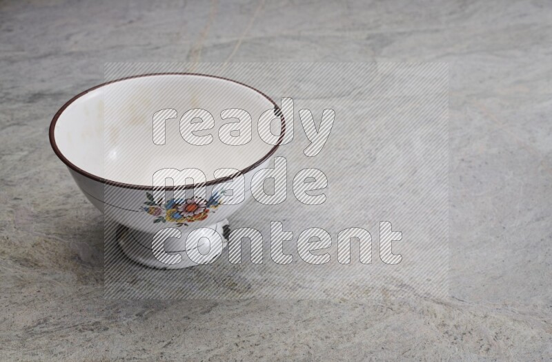 A vintage metal pot on grey marble background