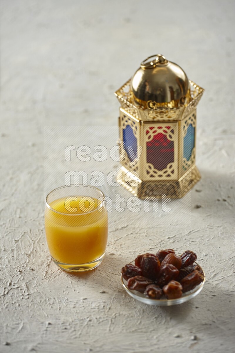A golden lantern with different drinks, dates, nuts, prayer beads and quran on textured white background