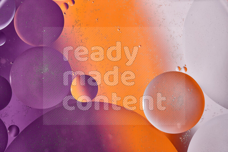 Close-ups of abstract oil bubbles on water surface in shades of white, orange and purple
