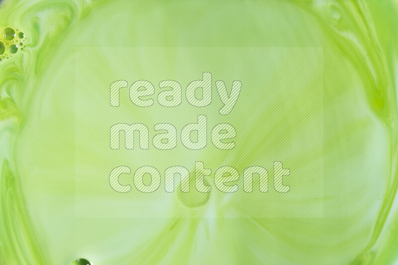 A close-up of abstract swirling patterns in green gradients