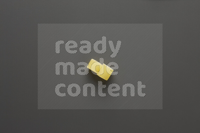 Big rings pasta on grey background