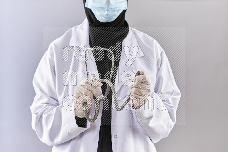Female doctor wearing an abaya and medical attire in different positions