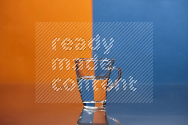 The image features a clear glassware filled with water, set against orange and blue background