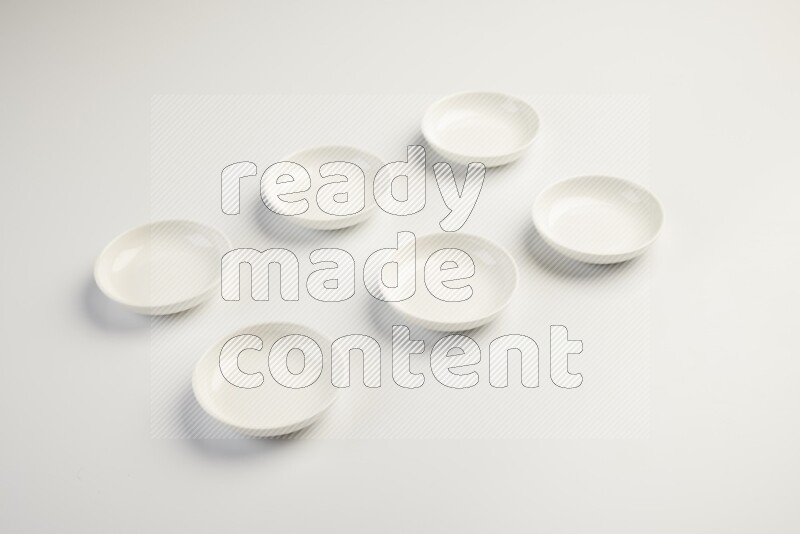white ceramic round sauce dish on white countertop
