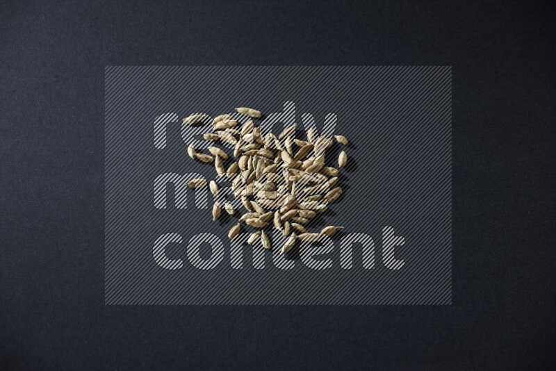 Cardamom seeds on black flooring