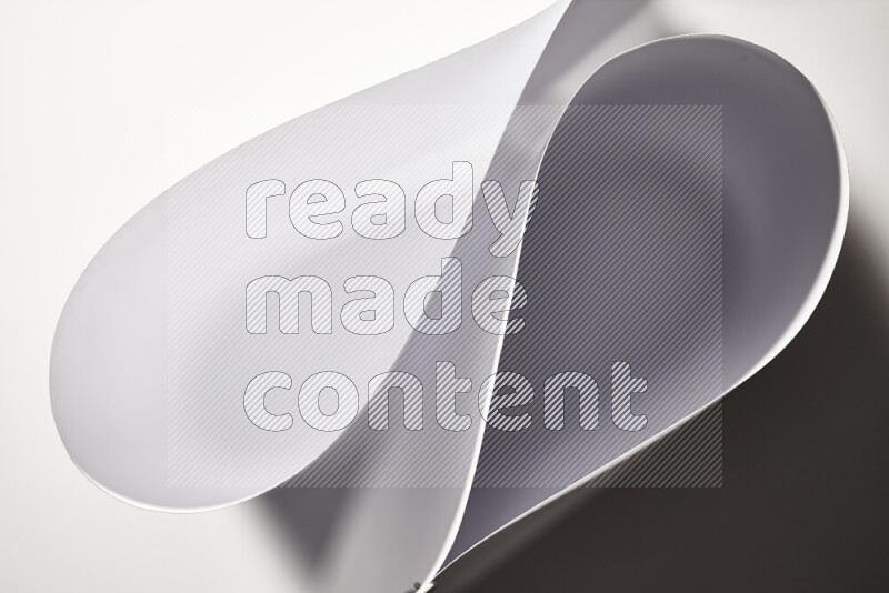 An abstract art of paper folded into smooth curves in grey gradients