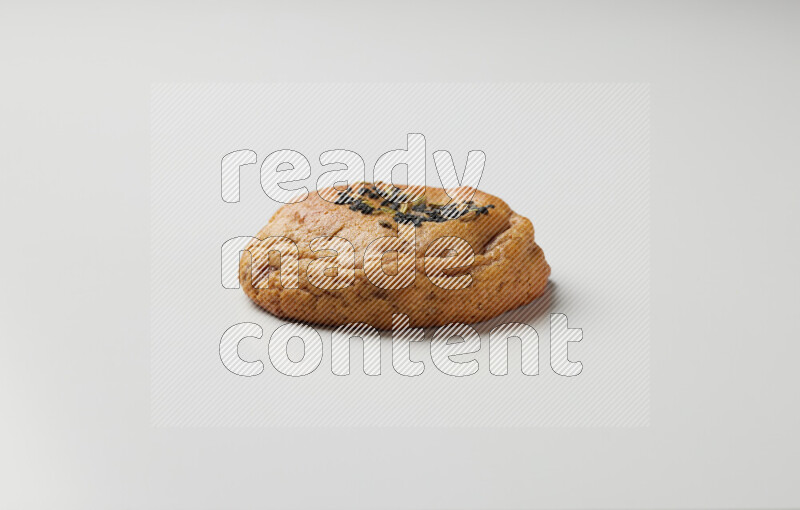 Hasawi cookie field with date and decorated by black seed and Anise grain on a white background