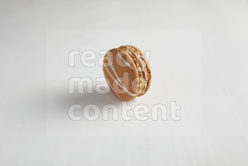 45º Shot of Brown Irish Cream macaron on white background