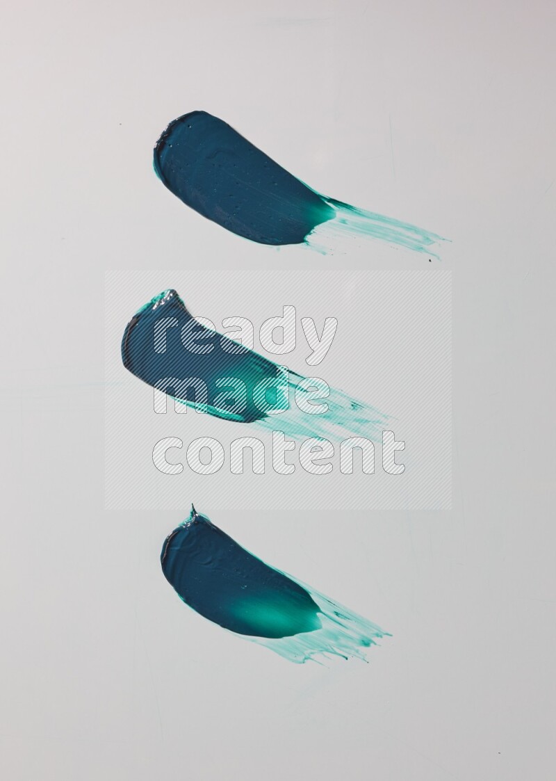 Turquoise painting knife strokes on white background
