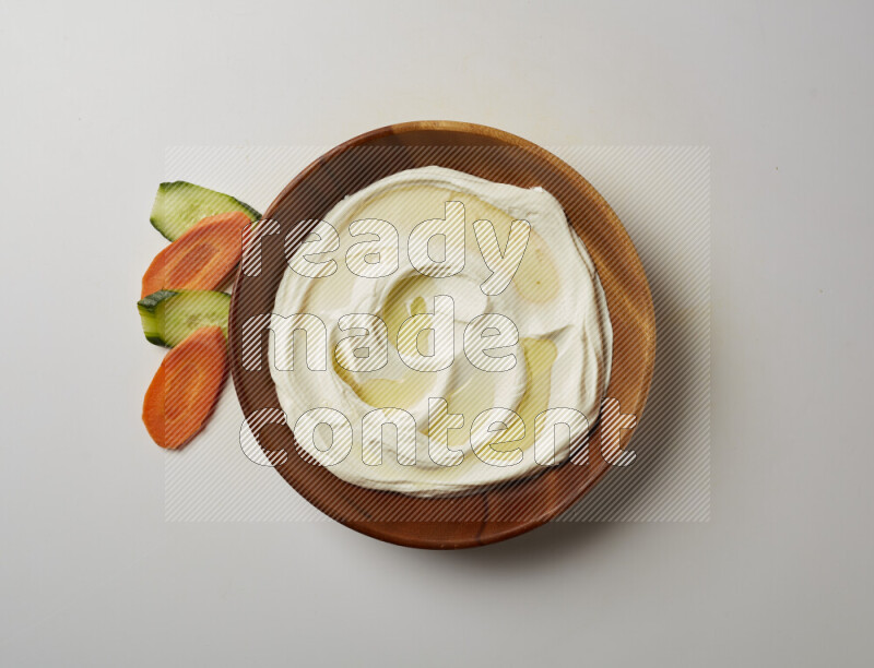 Lebnah garnished with olive oil in a wooden plate on a white background