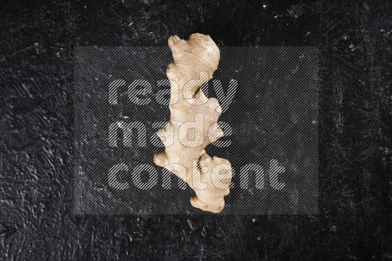 Fresh ginger root on black background