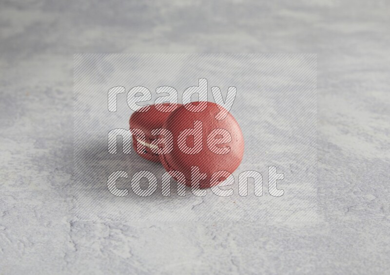 45º Shot of two Red Velvet macarons  on white  marble background