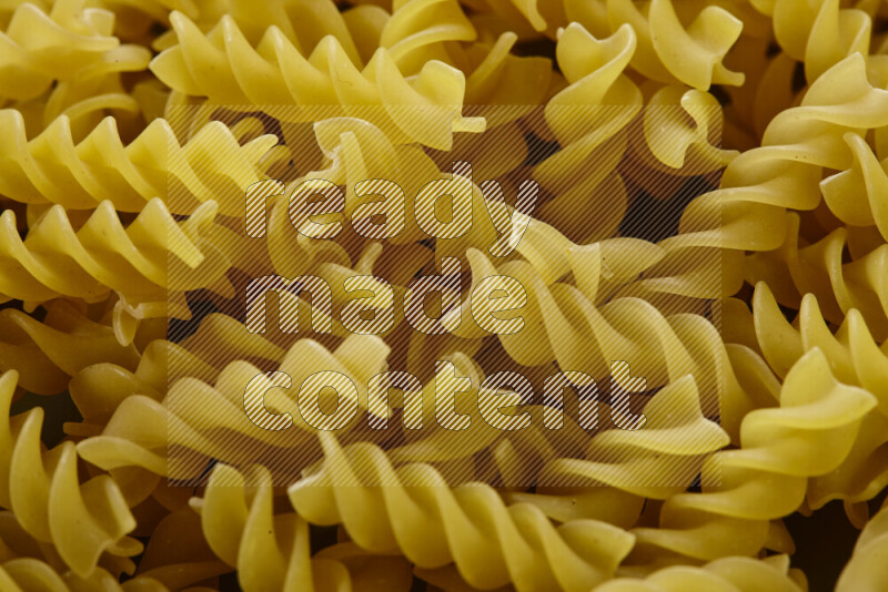 Fusilli pasta on grey background