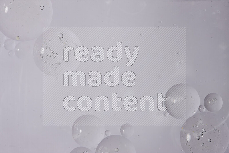 Abstract oil droplets in a water surface on white background