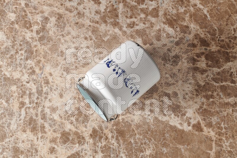 A vintage milk can on beige marble background
