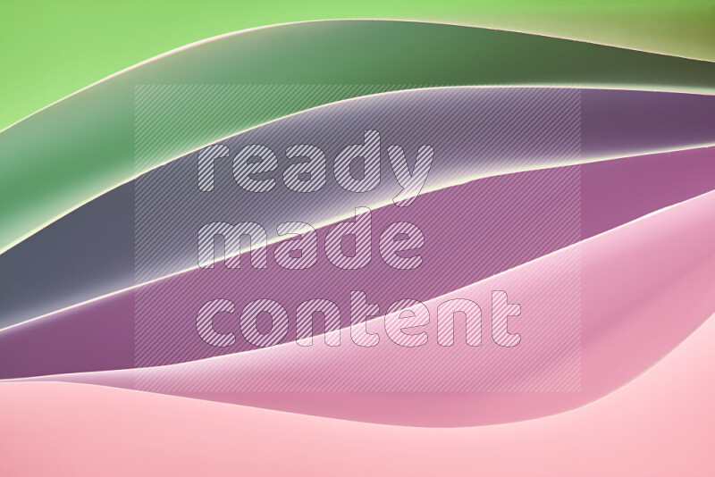 This image showcases an abstract paper art composition with paper curves in green and pink gradients created by colored light