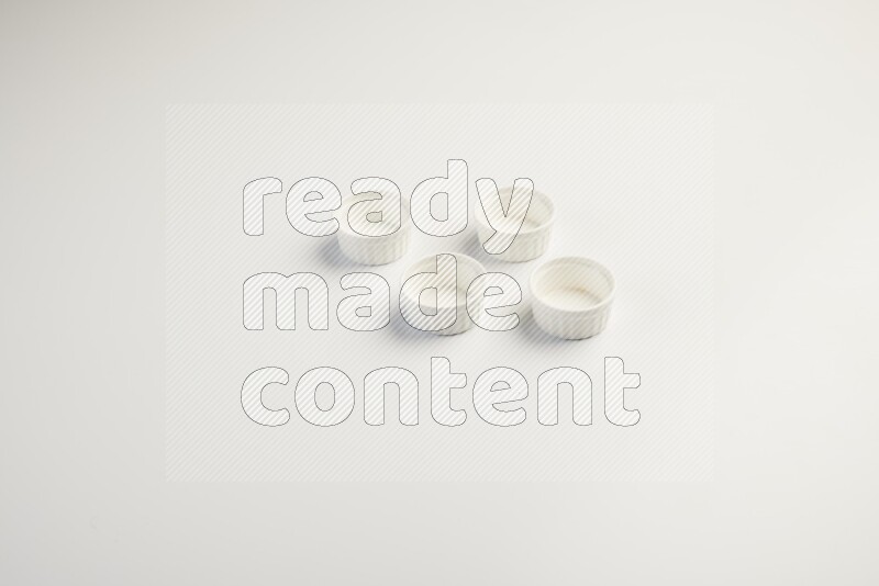 white ceramic round sauce dish on white countertop