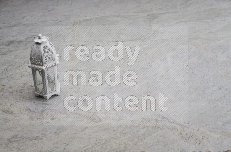 A candle lantern on grey marble background