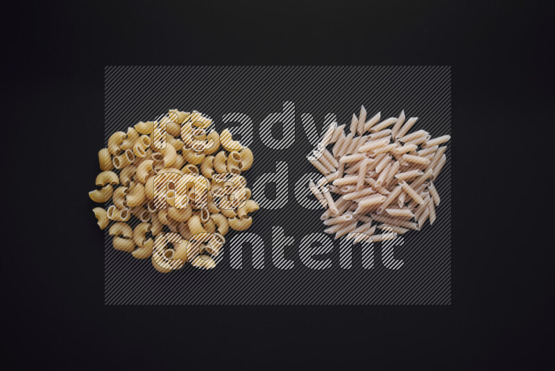 Different pasta types in bunches on black background