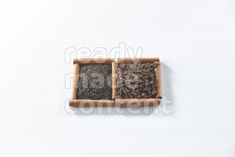 2 squares of cinnamon sticks full of black tea and cloves on white flooring