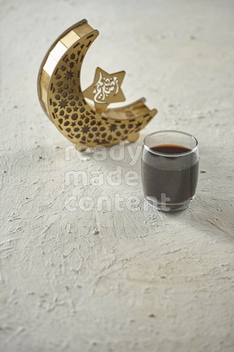 A wooden golden crescent lantern with different drinks, dates, nuts, prayer beads and quran on white background