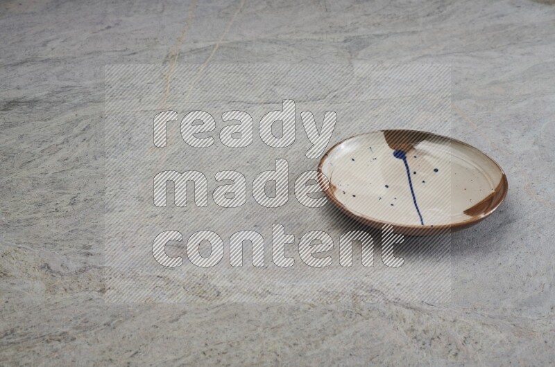 Multicolored Pottery Plate On Grey Marble Flooring
