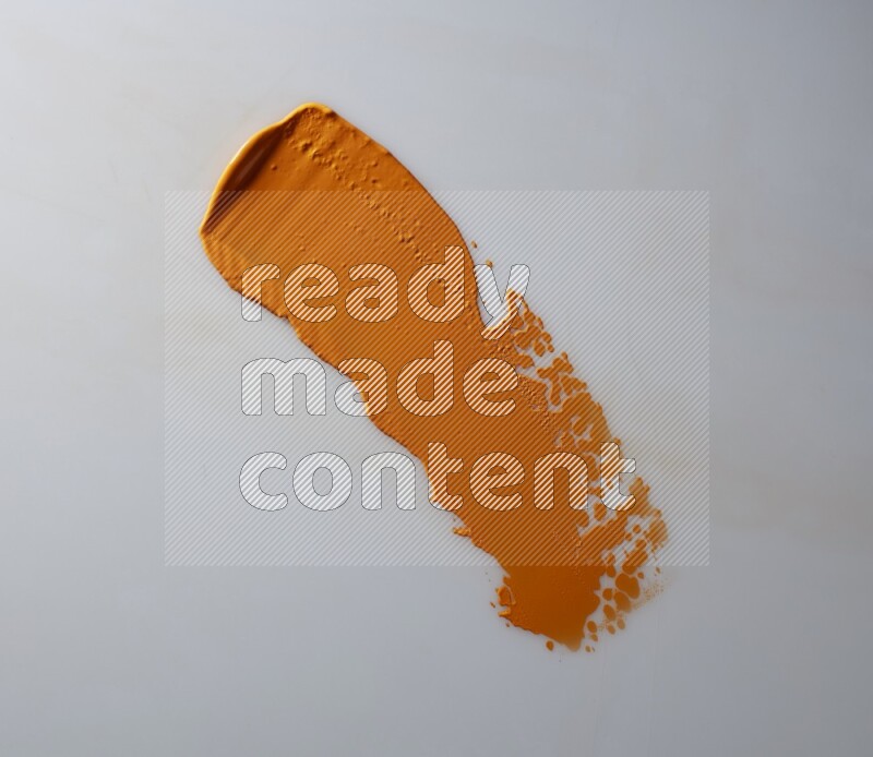 An orange straight painting knife stroke on white background