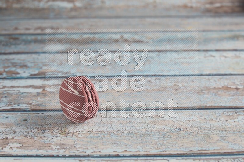 45º Shot of Red Poppy Flower macaron on light blue wooden background