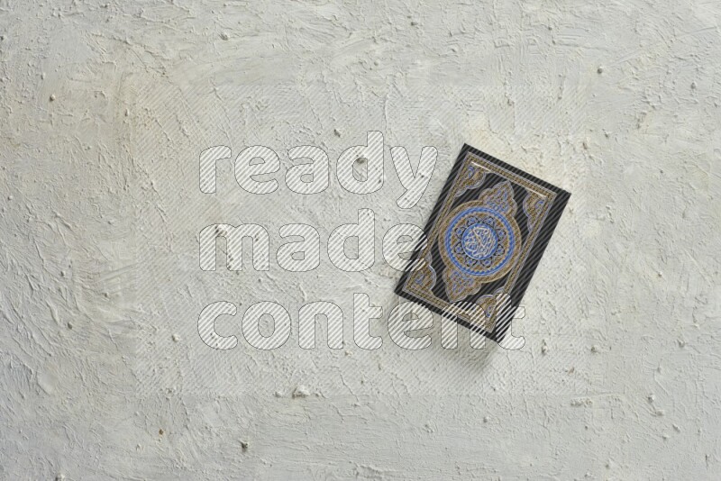 Quran with a prayer beads on white background