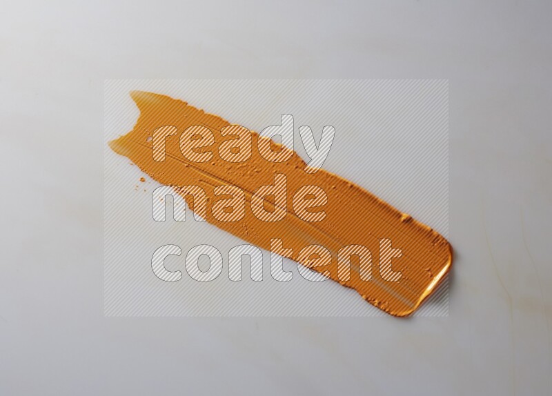 An orange straight painting knife stroke on white background