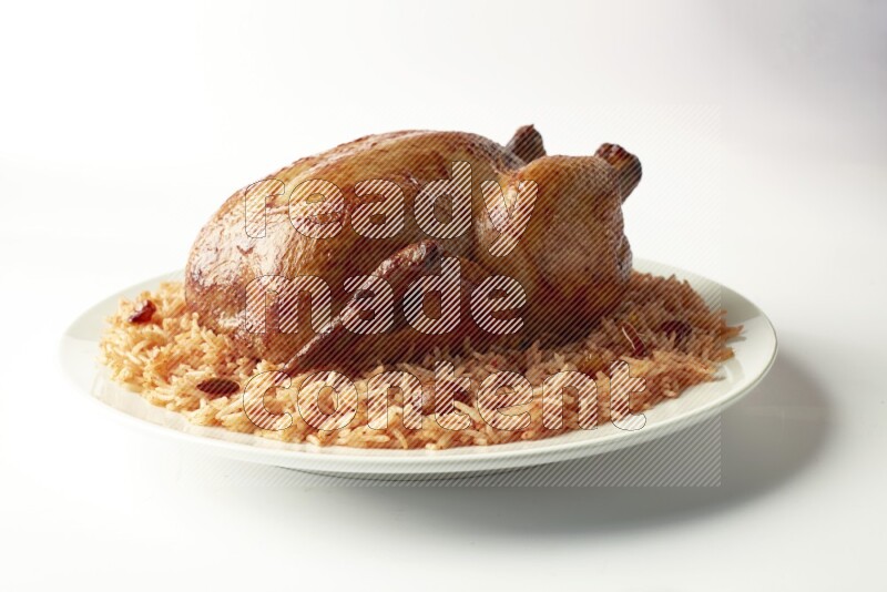 red basmati Rice with  whole roasted chicken on a white rounded plate  direct  on white background