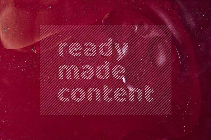 Close-ups of abstract oil bubbles on water surface in shades of red