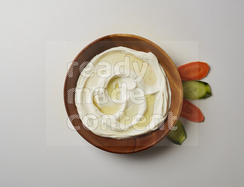 Lebnah garnished with olive oil in a wooden plate on a white background