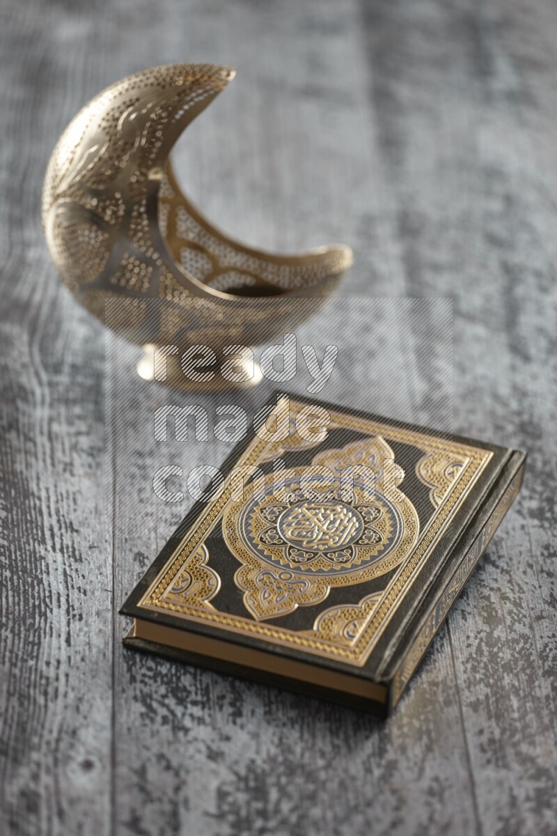 A silver lantern with different drinks, dates, nuts, prayer beads and quran on grey wooden background