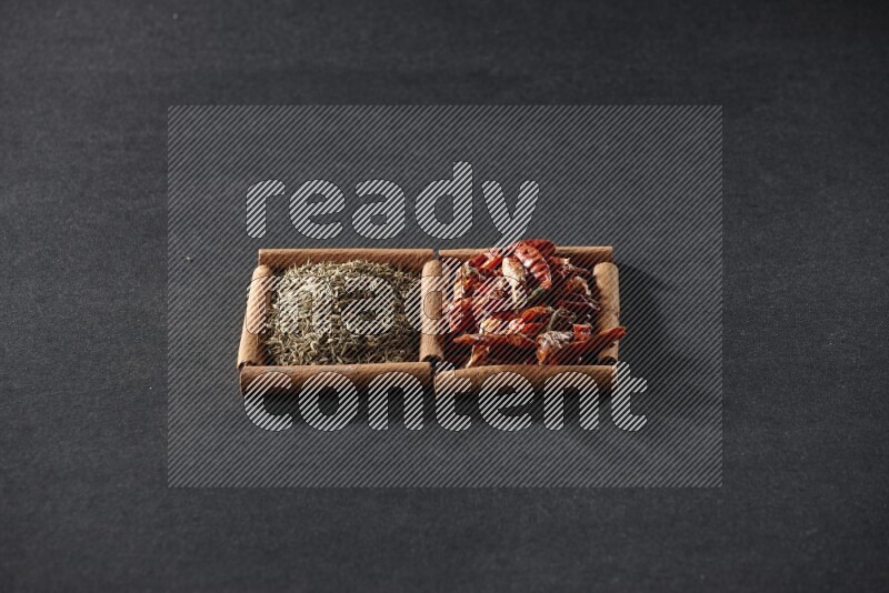 2 squares of cinnamon sticks full of chilis and cumin on black flooring