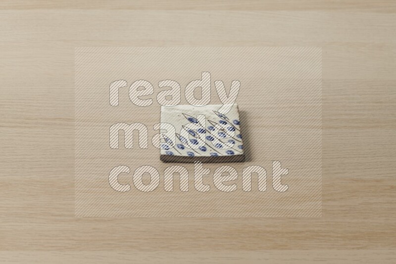 A decorative coaster on light wooden background