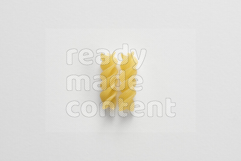 Fusilli pasta on white background
