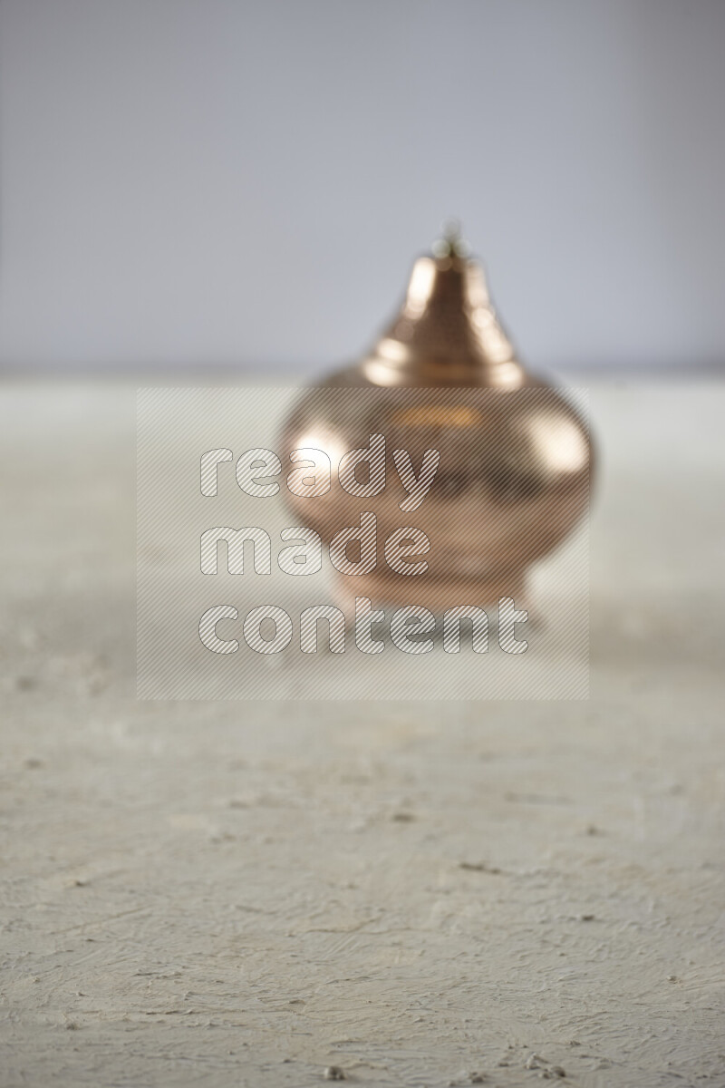 A lantern placed on a textured white background
