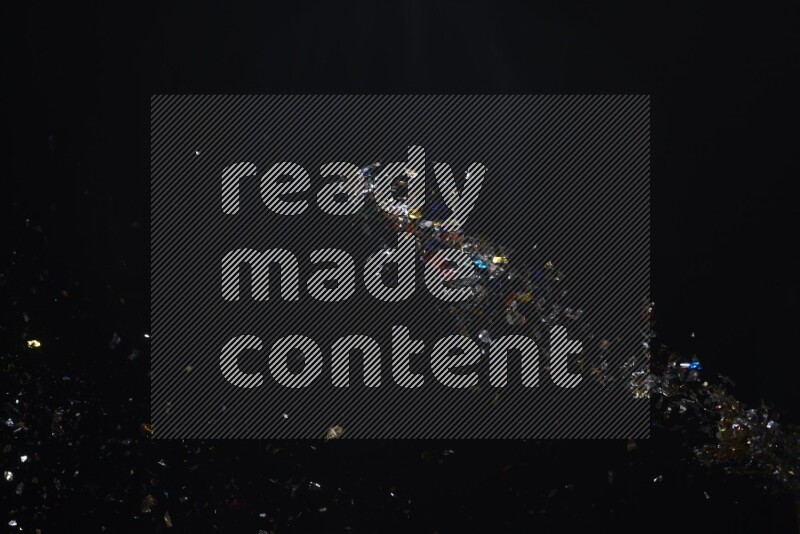 Falling multicolored confetti on black background